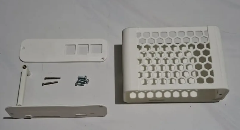 The 3D-printed case, open, with screws