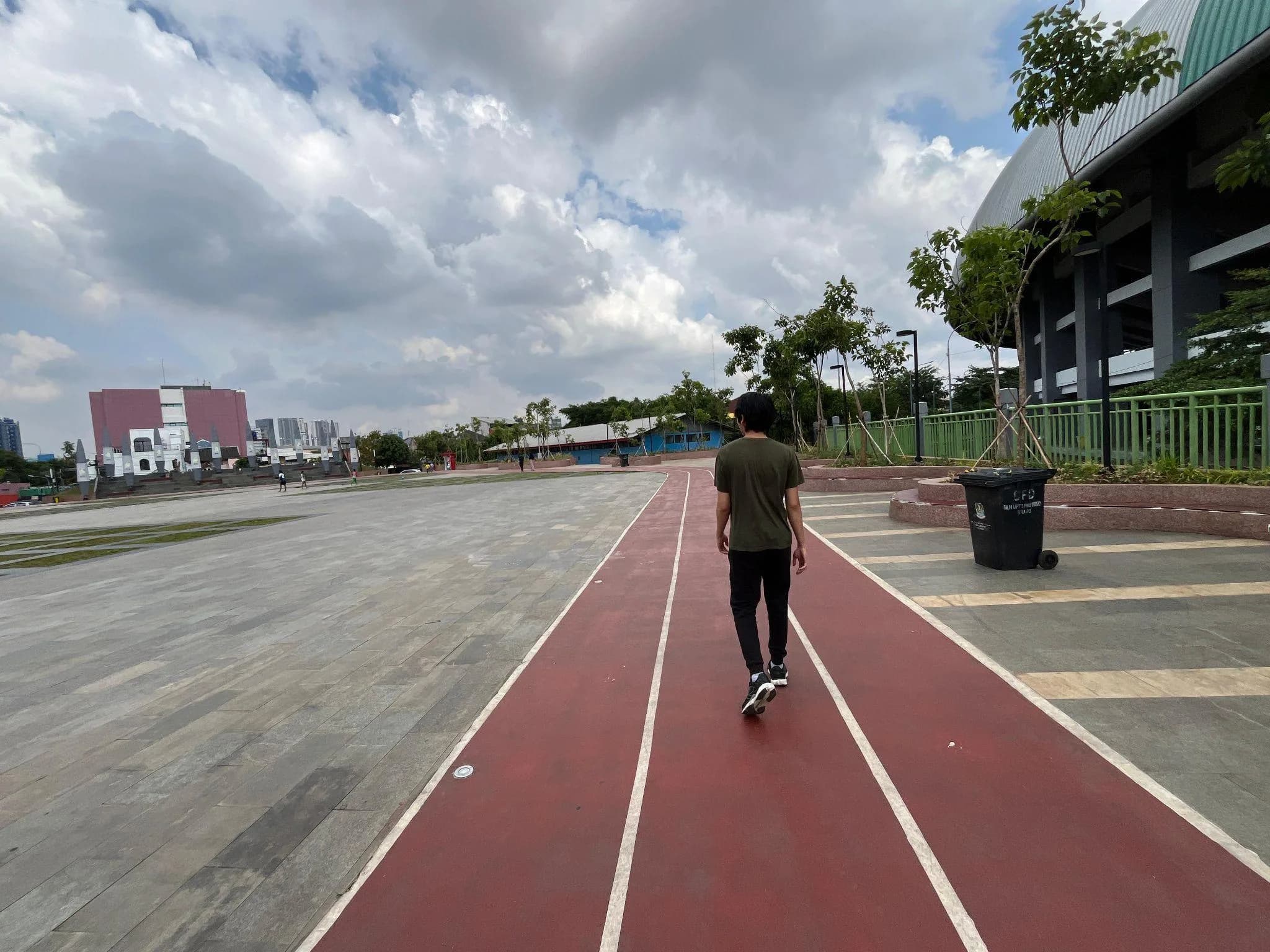 The red running lanes of Patriot Candrabhaga Stadium, seen from a runner's eye level